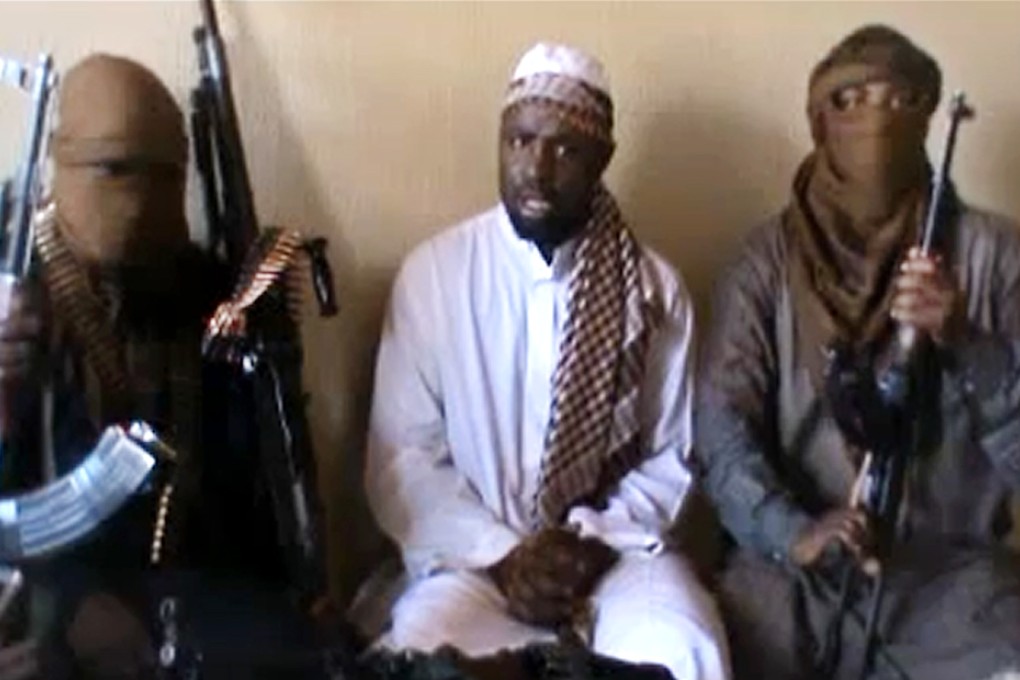 Boko Haram leader Abubakar Shekau is flanked by militants. Photo: AFP