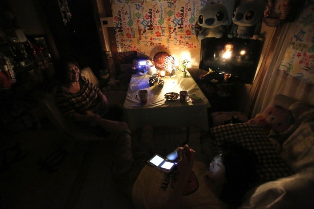 Saving on the power bill with candles in Tokyo. Photo: Reuters