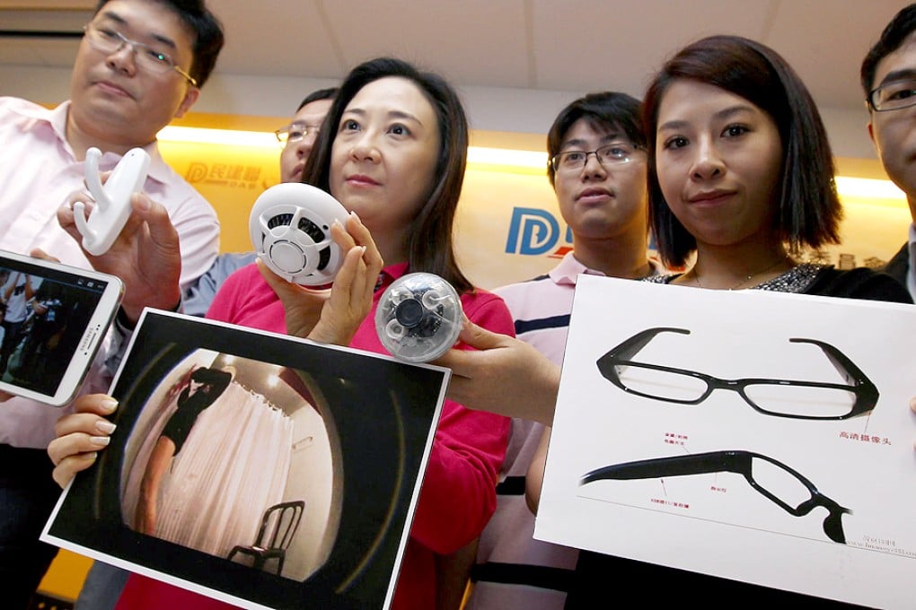 Elizabeth Quat (in red) and others show examples of spy gadgets being used to prey on unsuspecting women. Photo: Jonathan Wong