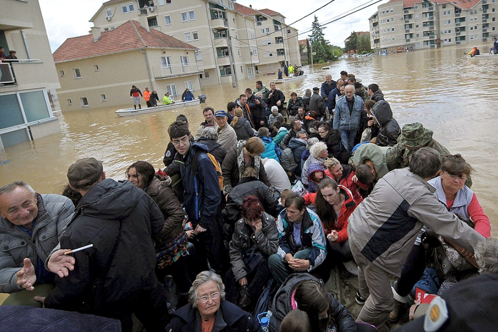 Dozens of people stranded in the flooded Serbian town of Obrenovac, 40km from Belgrade, are evacuated on an amphibious vehicle. Photo: AFP