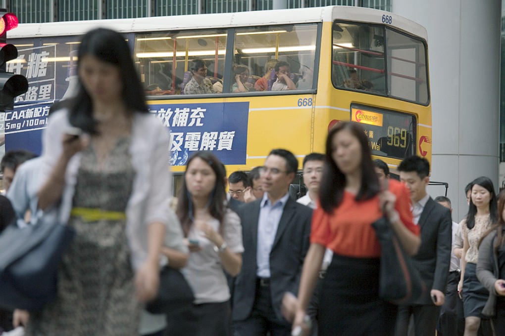 More than half of the local labour force work more than 44 hours a week, a survey has found. Photo: Bloomberg