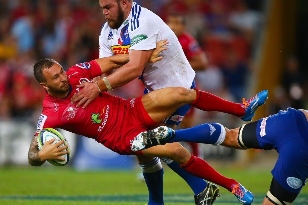 Stormers tighthead prop Frans Malherbe (right) tackles Reds fly-half Quade Cooper in a Super 15 match in March.  Photo: AFP