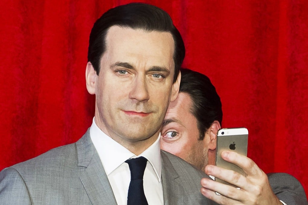 Actor Jon Hamm (right) taking a selfie at the unveiling of his wax figure at Madame Tussauds in New York. Photo: AP