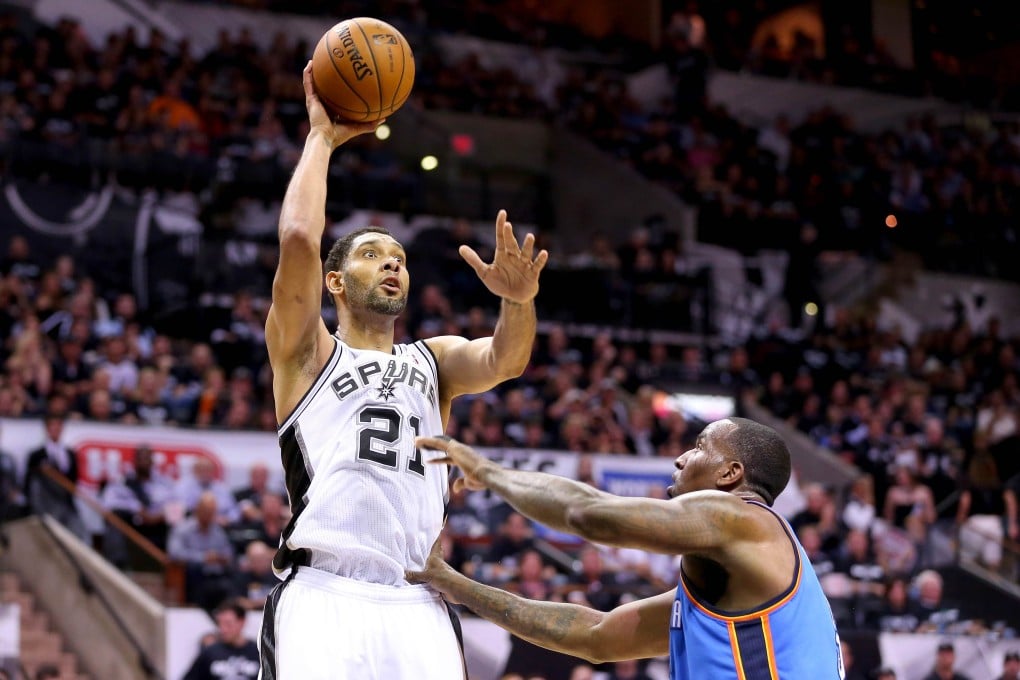 Tim Duncan of the San Antonio Spurs shoots over Kendrick Perkins of the Oklahoma City Thunder in game one of their Western Conference finals. Photo: AFP