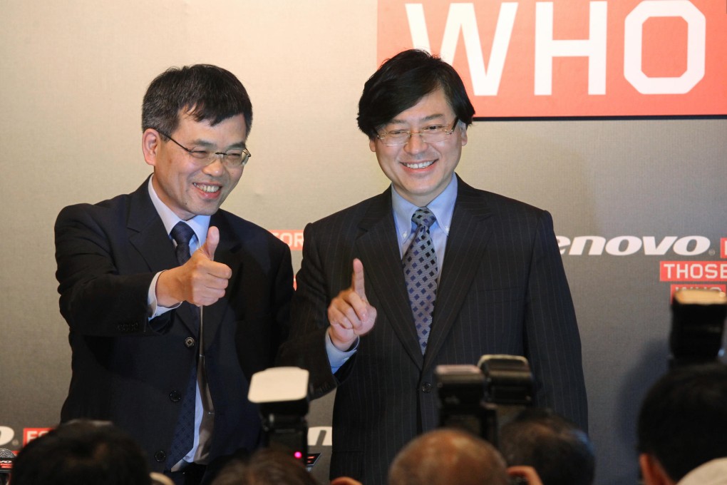 Wong Wai-ming (left) and Yang Yuanqing report the firm's earnings in Admiralty. Photo: May Tse