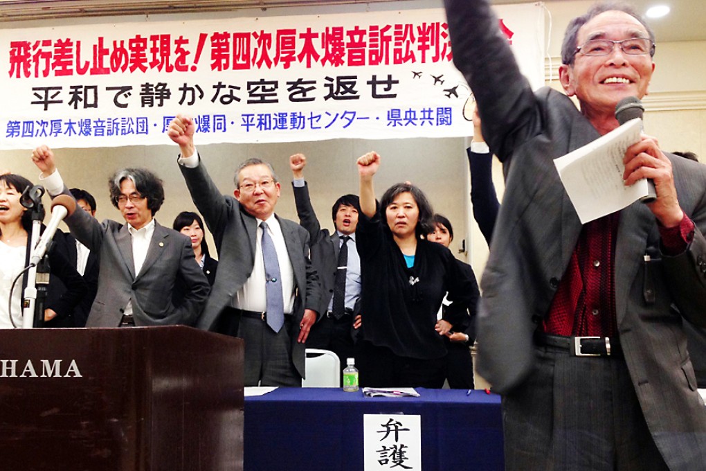 Supporters and plaintiffs celebrate victory in a legal suit to suspend night flights of Japanese military planes in Yokohama. Photo: AFP