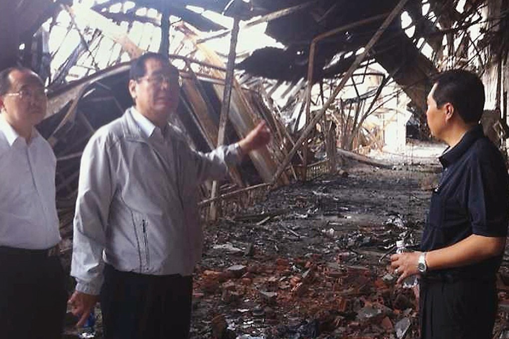 Tseng Yung-chuan inspects some of the damage yesterday. Photo: CNA