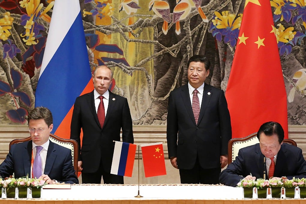 Gazprom CEO Aleksey Miller (left) and Zhou Jiping (right), head of China National Petroleum Corporation, ink the deal as Vladimir Putin and Xi Jinping look on. Photo: Xinhua