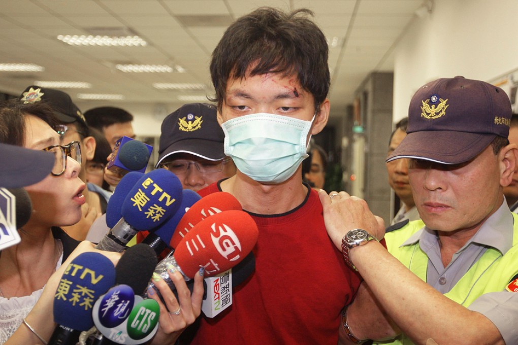 Cheng Che is led away after the scene. He reportedly has admitted the attack. Photo: AFP