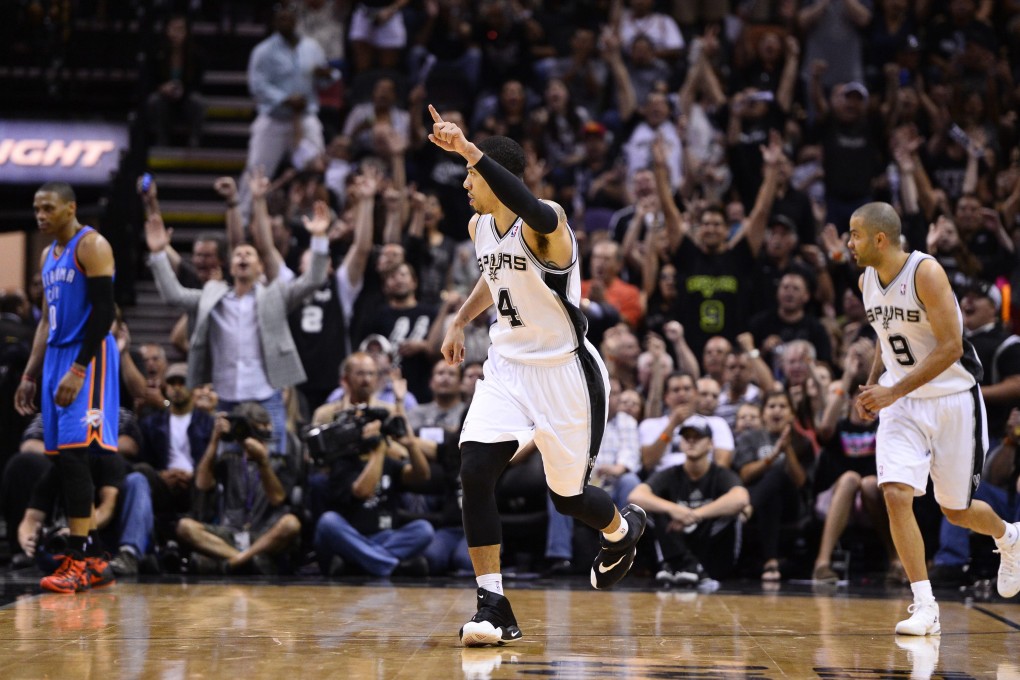San Antonio Spurs guard Danny Green reacts after scoring, with a dejected Thunder's Russell Westbrook (left) in game two of their Western Conference finals. Photo: EPA