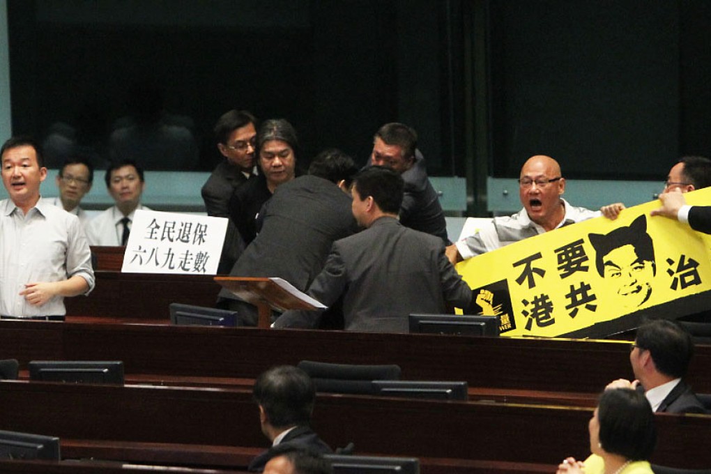 People Power's Chan Chi-chuen (left), "Long Hair" Leung Kwok-hung (centre) join in the protest after Albert Chan throws a bun in Chief Executive Leung Chun-ying's way. Photo: Felix Wong