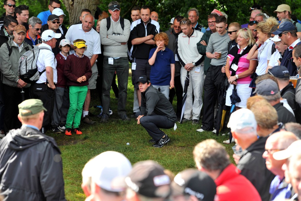 All eyes on Rory McIlroy as he tries to find his way back to the fairway on the fifth hole. Photo: AFP