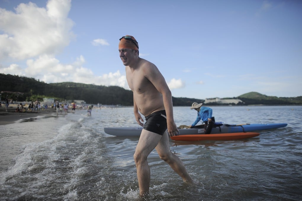 Simon Holliday is a happy man as he completes his 35km swim from Hong Kong to Macau. Photo: SMP Pictures