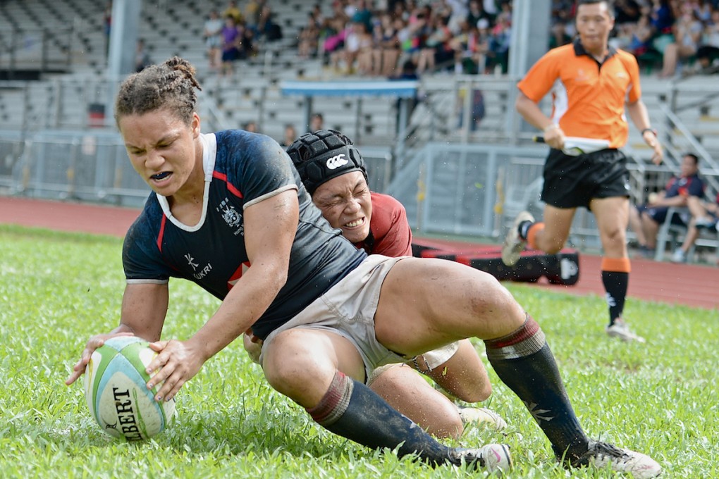 Natasha Olson-Thorne dots down one of three tries she scored for Hong Kong against Singapore on Saturday. Photos: ARFU