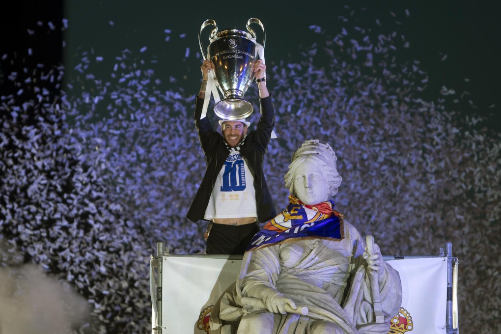 Real Madrid's Sergio Ramos lifts the trophy next to the Cibeles statue in Madrid, Spain, after his team won the Champions League. Photo: AP
