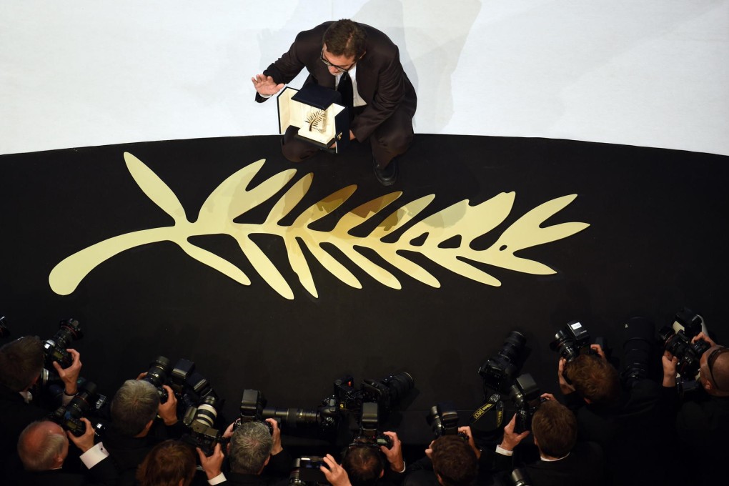 Turkish director Nuri Bilge Ceylan poses with the Palme d'Or, the top award, for his film Winter Sleep during the closing ceremony of the Cannes Film Festival. Photo: AFP