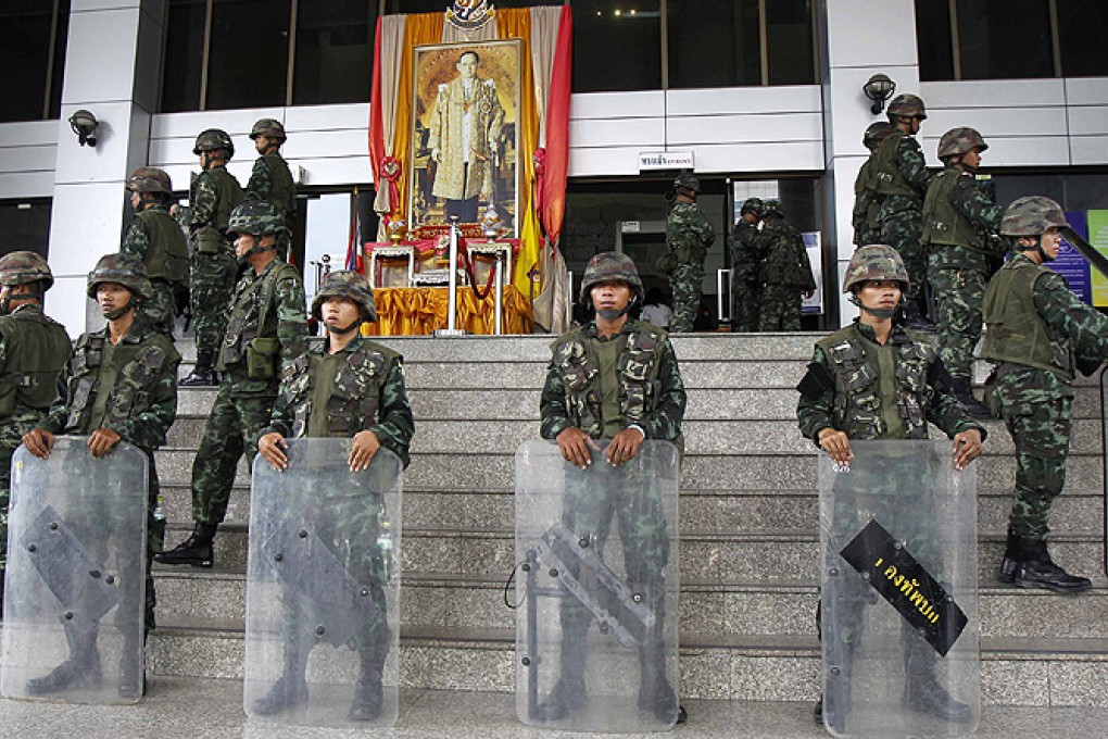 Soldiers stand guard at the criminal court in Bangkok. Photo: Reuters