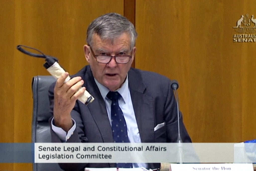 Heffernan shows a fake pipe bomb during a committee hearing in Canberra. Photo: AP