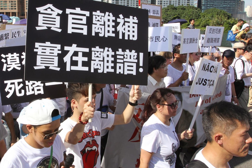 Protesters march in Macau yesterday over a bill granting a generous welfare package to the outgoing chief executive and top officials. Photo: Dickson Lee