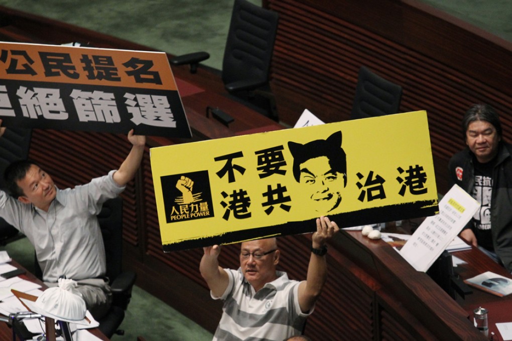 (From left) Lawmakers Raymond Chan Chi-chuen, Albert Chan Wai-yip and Leung Kowk-hung protest during Chief Executive Leung Chun-ying's Question and Answer Session in the Legislative Council.