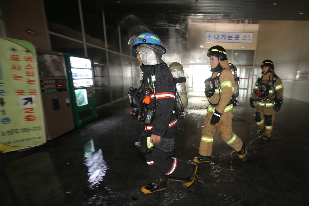 Firefighters respond to the scene in Goyang, where fire raged through an underground shopping centre and killed several people. Photo: EPA