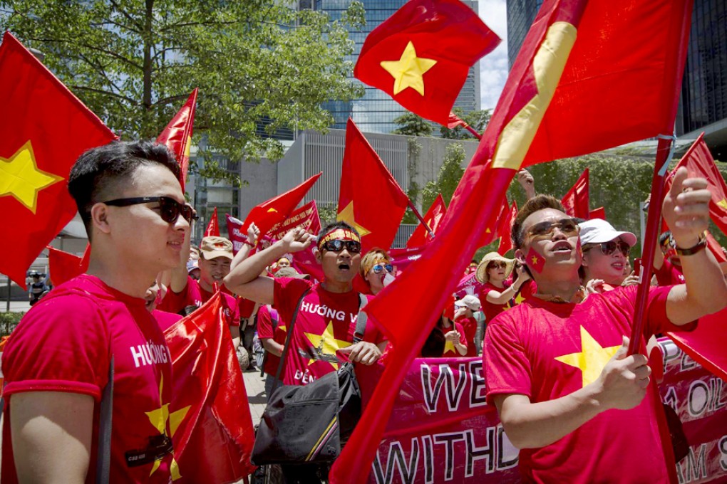 Protesters brandish Vietnamese flags. Photo: Reuters
