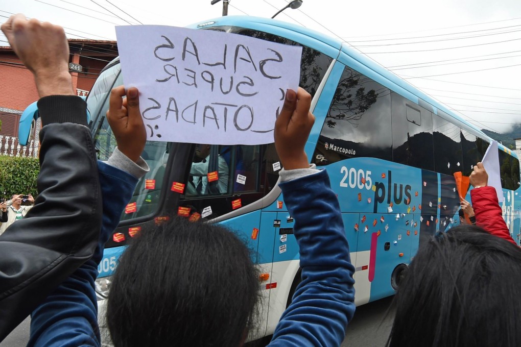 Teachers block the arrival of Brazil's bus. Photo: AFP