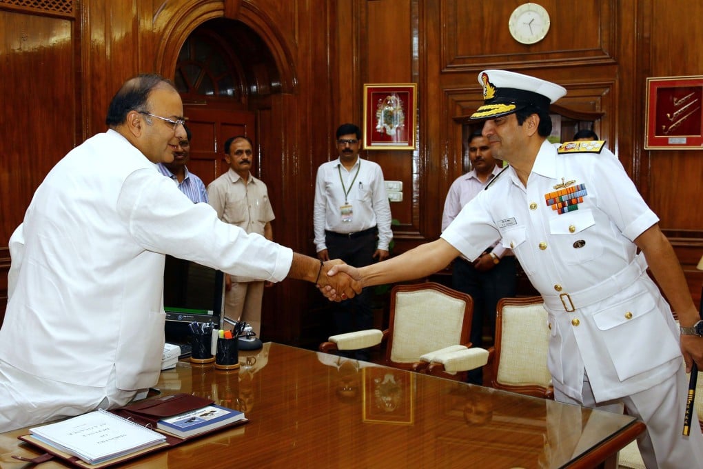 Indian Chief of Naval Staff Admiral R.K. Dhowan (right) shakes hands with new Indian Defence Minister Arun Jaitley at South Block in New Delhi. Photo: AP