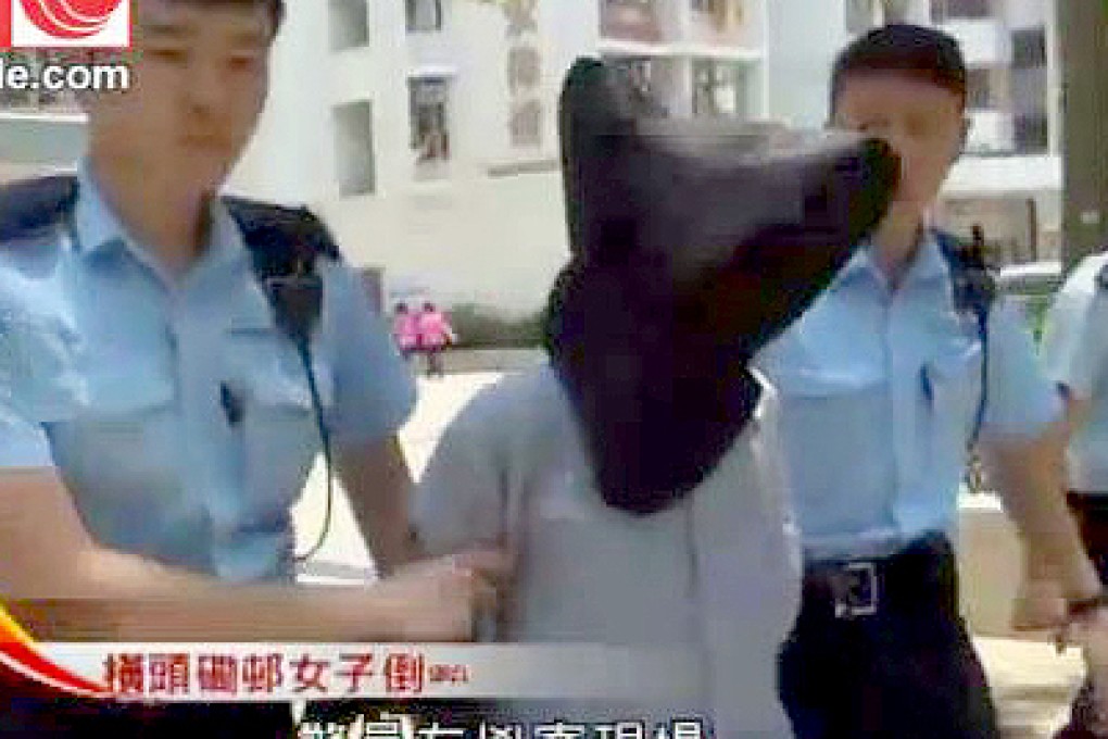 Police escort the murder suspect from the crime scene in Wong Tai Sin yesterday. Photo: SCMP Pictures