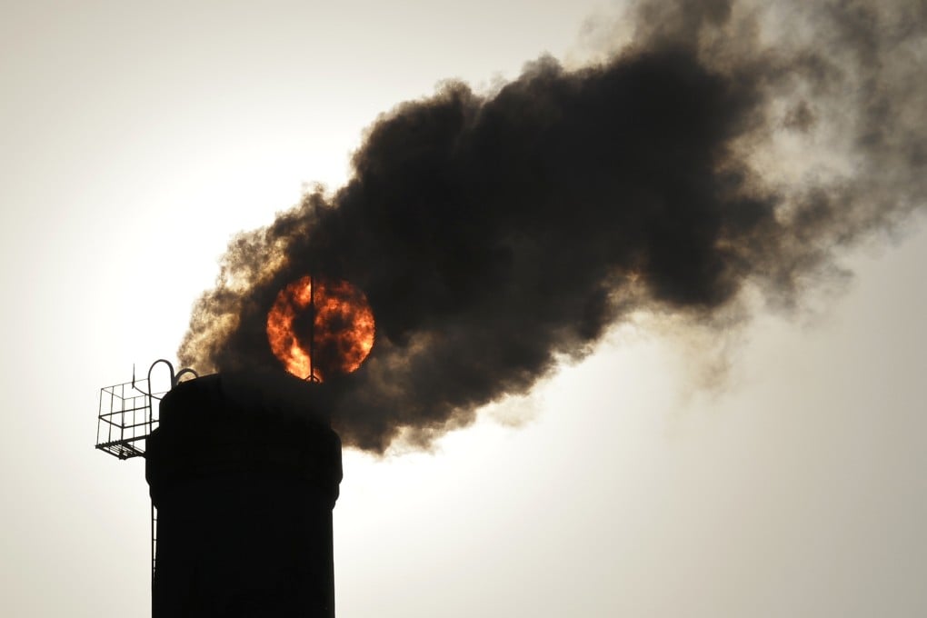 Smoke from a mainland factory covers a view of the sun. China, the world’s biggest emitter of climate-changing greenhouse gases. Photo: Reuters