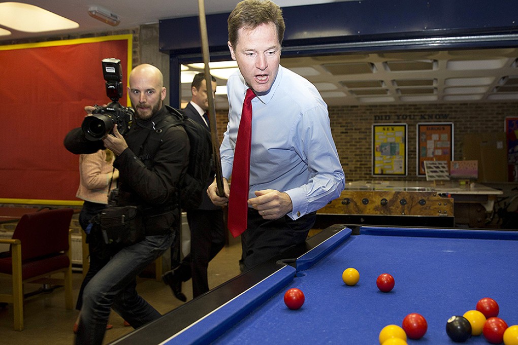 Britain's Deputy Prime Minister Nick Clegg plays pool during a visit to St Andrews Youth Club in London. Photo: Reuters