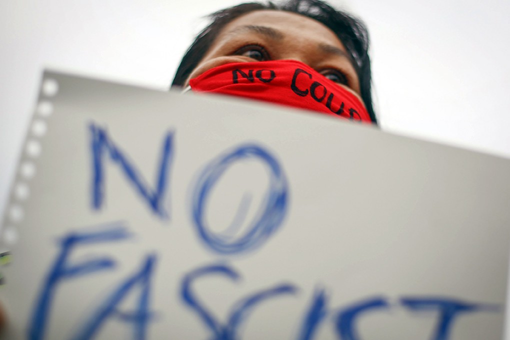 A woman protests against the military coup at Victory Monument in Bangkok. Photo: EPA