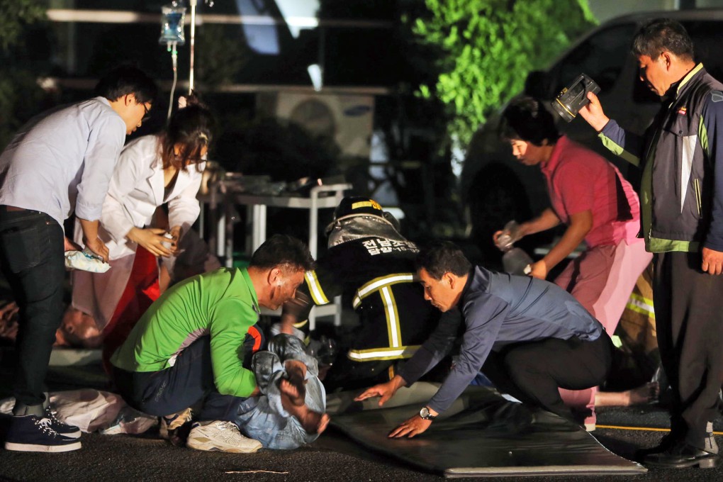 Rescue workers treat victims of a major fire at a hospital in Jangseong, South Korea. Photo: AP