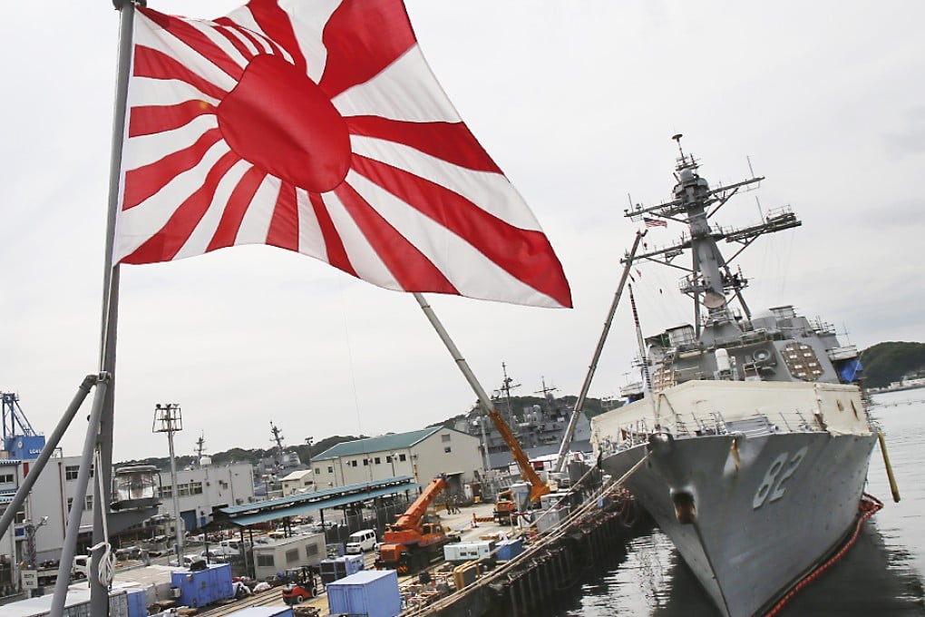 The Rising Sun Flag is flown aboard the Japan Maritime Self-Defense Force ship, LST Kunisaki, on May 27, 2014 in Yokosuka, Japan. Photo: AP