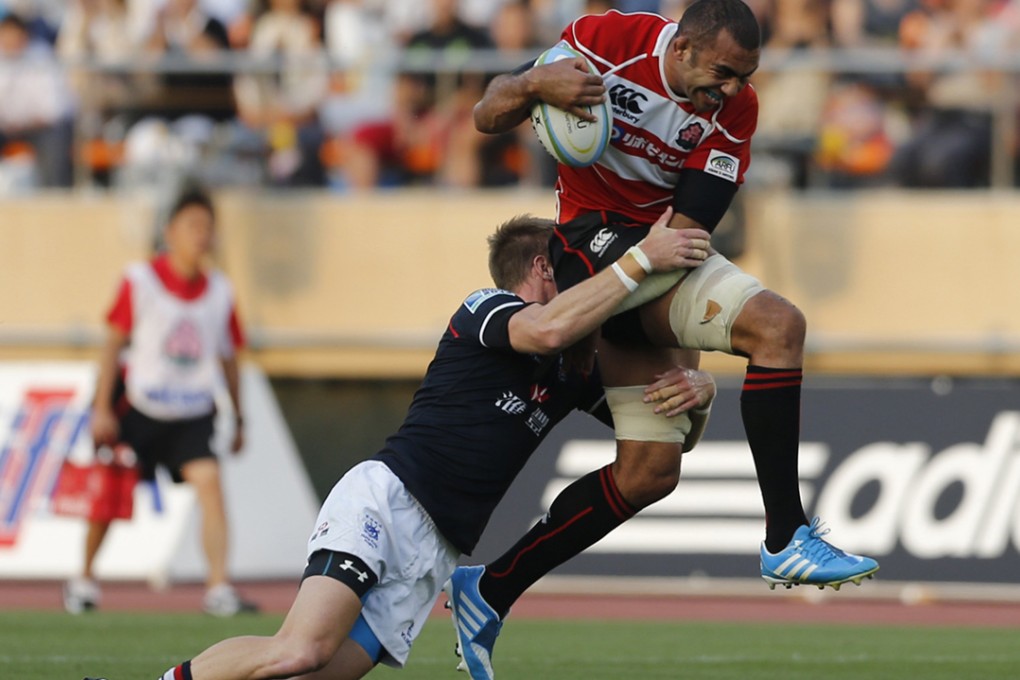 Alex McQueen demonstrates Hong Kong’s strength in defence as he tackles Japan captain Michael Leitch in Tokyo, but it was their lack of possession that proved too costly for the visitors. Photo: Reuters