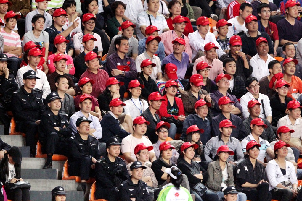Chinese spectators watch a soccer match with Japan. This year's Brazil matches will be broadcast in the odd hours, driving some fans to try and skip work. Photo: K.Y. Cheng