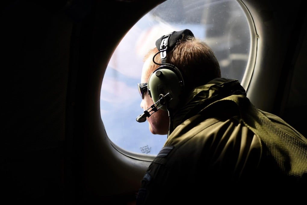A crewman on a search plane over the Indian Ocean. Photo: Reuters
