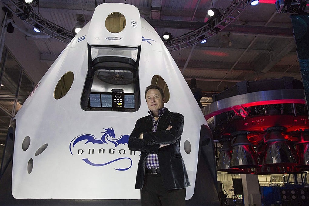 SpaceX chief Elon Musk with the Dragon V2, which can land with the accuracy of a helicopter. Photo: AFP