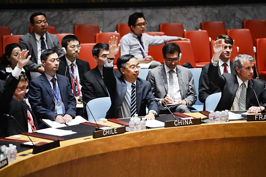 Wang Min (centre), China's deputy permanent representative to the United Nations, votes on a draft resolution regarding UN mission in South Sudan, at the UN headquarters in New York. Photo: Xinhua