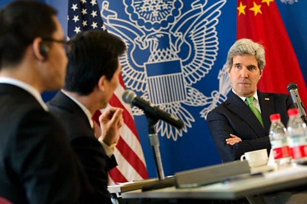 The US said it was 'troubled' by reports that online activist and blogger Zhang Jialong (first left) who met John Kerry had been fired. Photo: Reuters