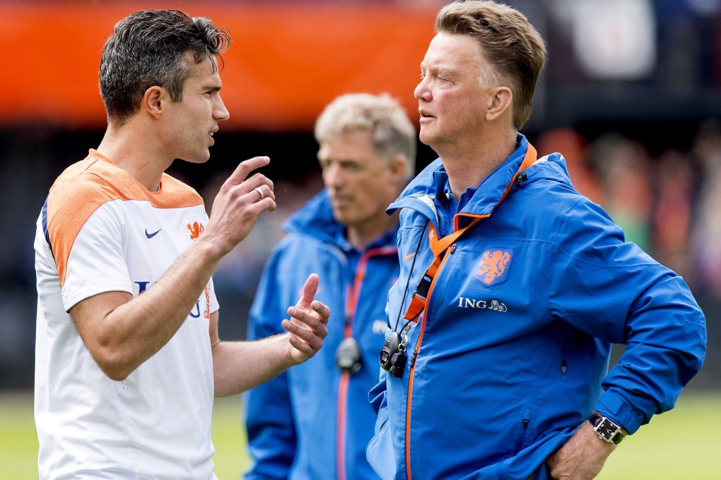 Dutch national Louis van Gaal (right) talks to his captain, Robin van Persie, at a training session in Rotterdam. Photo: EPA