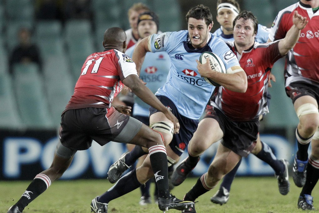 Dave Dennis, pictured here leading the charge for the Waratahs, scored a late captain's try to help his team to a 33-17 victory over the Waikato Chiefs on Saturday. Photo: AP