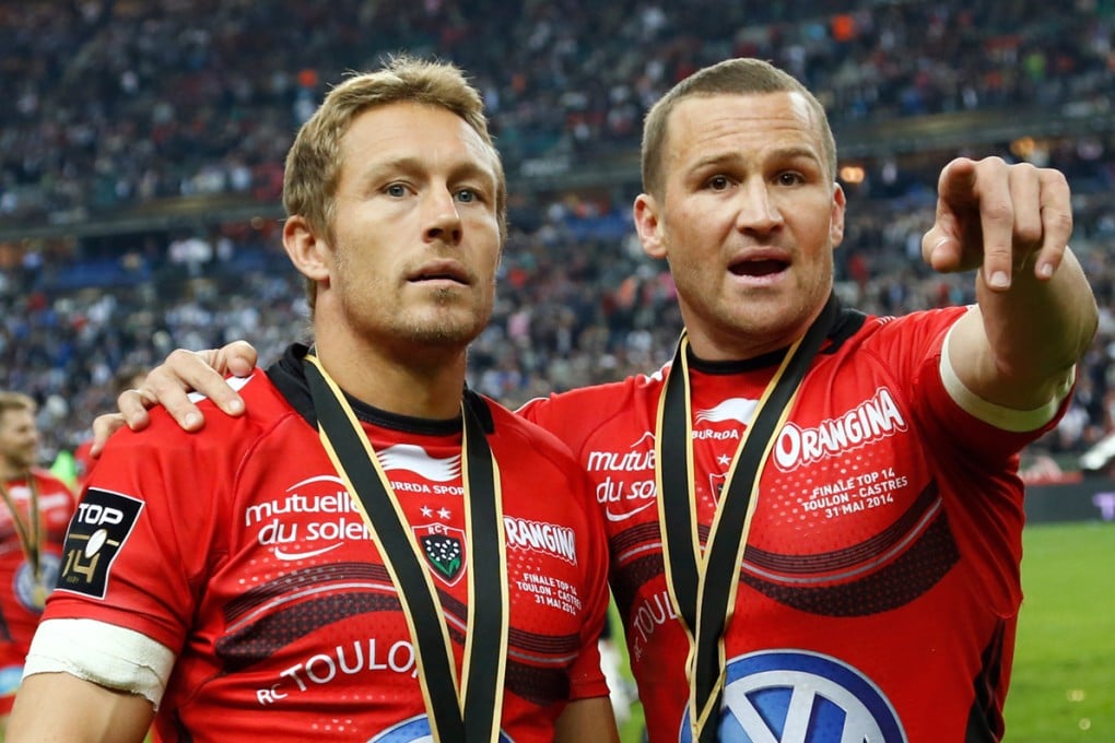 Jonny Wilkinson and Matt Giteau celebrate on the pitch after Toulon win the French Top 14 final against Castres Olympique in Paris on Saturday. Photos: AFP