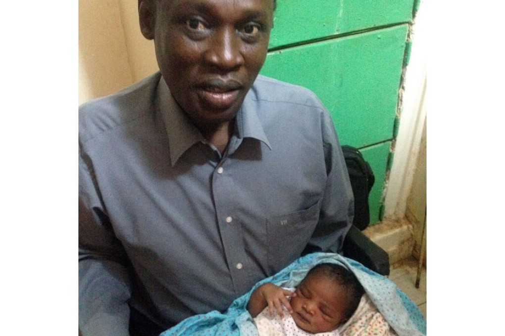 The woman's husband with their newborn daughter. Photo: AFP