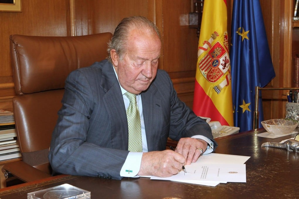 King Juan Carlos signs over power. Photo: EPA