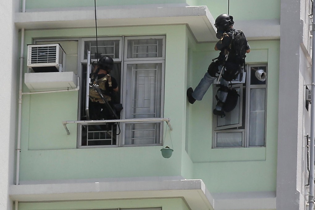 Two "Flying Tigers" officers slide down ropes and enter Li Tak-yan's apartment as the stand-off ends. Photo: Edward Wong