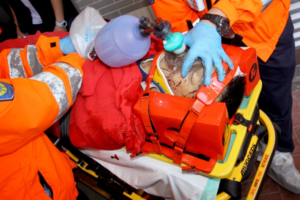 A man believed to be alleged gunman Li Tak-yan is taken from the apartment building to an ambulance on Sunday. Photo: Dickson Lee