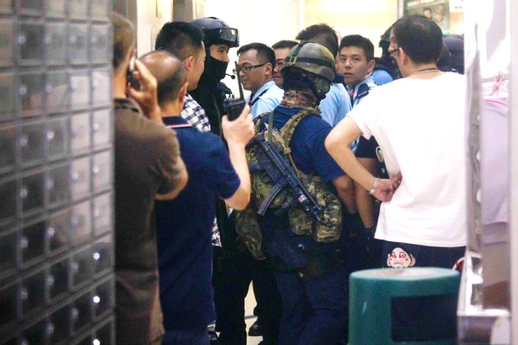 Elite police officers inside Lok Ching House in Kowloon Bay on Sunday. Photo: Reuters