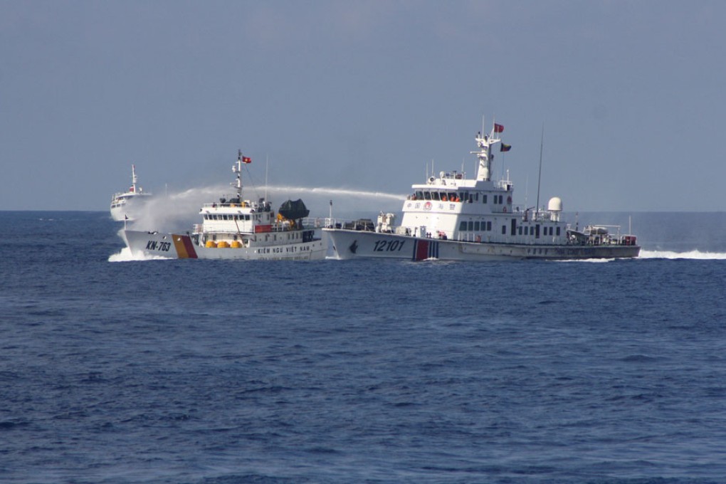 A China Coast Guard ship (right) uses water cannons to expel a Vietnam marine surveillance ship that has intruded into a Chinese company's work zone in South China Sea.