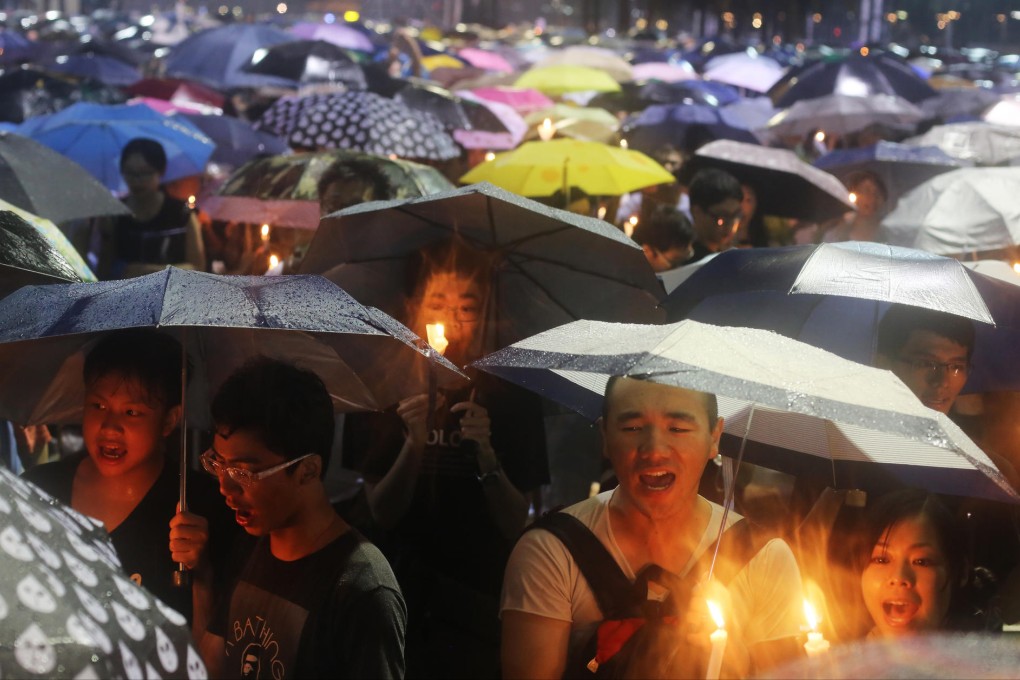 Hongkongers brave the rain at last year's vigil. Photo: Sam Tsang